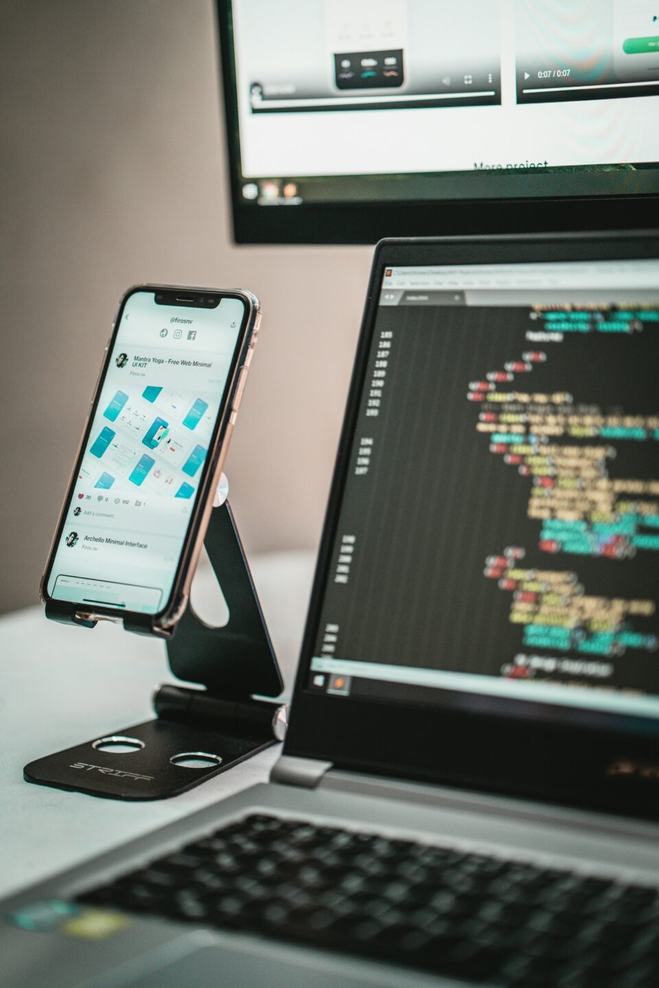 Mobile application interface and source code displayed across devices during web application, API, and mobile app security testing.