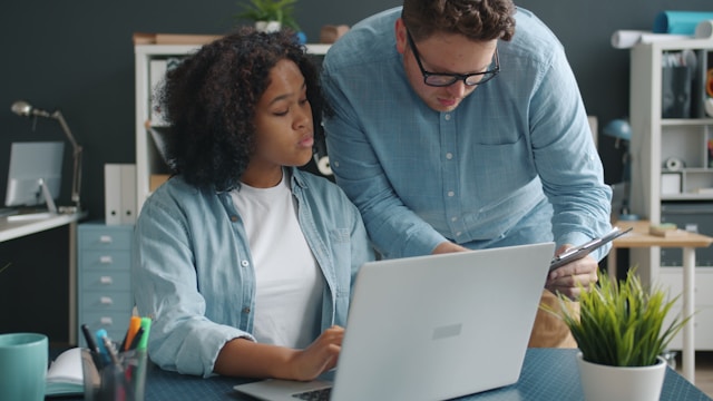 Team members receiving onsite custom cybersecurity and technical training with hands-on guidance and real-world support in a workplace environment.
