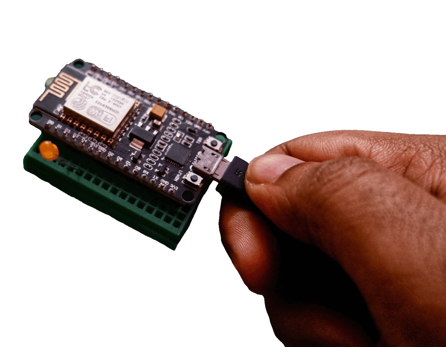 Hand plugging a Wi-Fi-enabled IoT microcontroller into a development board for embedded device testing and hardware security research.